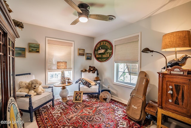 sitting room featuring ceiling fan