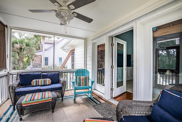 sunroom / solarium featuring ceiling fan