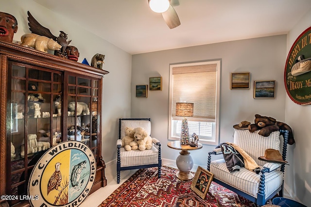 sitting room featuring ceiling fan