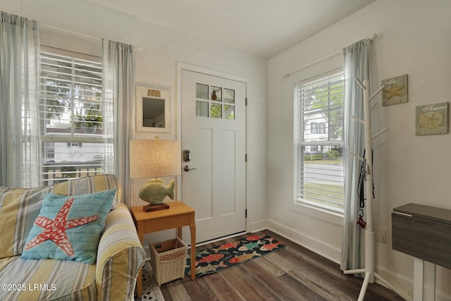 foyer featuring dark wood finished floors and baseboards