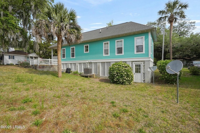 back of house with a yard and central AC