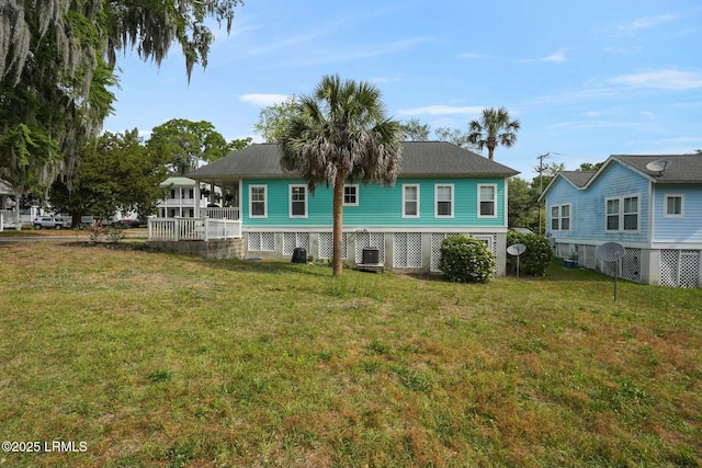 back of property featuring a lawn