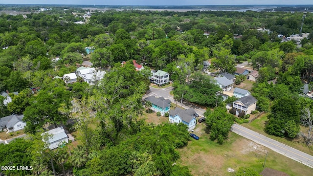 bird's eye view featuring a residential view and a wooded view