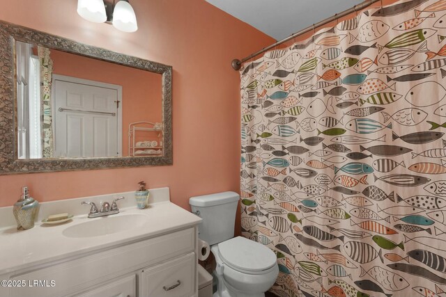 bathroom with vanity, toilet, and curtained shower