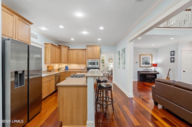 10 Old Barn Rd, Beaufort, SC 29907 - kitchen featuring appliances with stainless steel finishes, open floor plan, a kitchen breakfast bar, dark wood finished floors, and ornamental molding