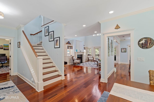 10 Old Barn Rd, Beaufort, SC 29907 - foyer featuring ornamental molding, stairs, dark wood-style flooring, a fireplace, and recessed lighting