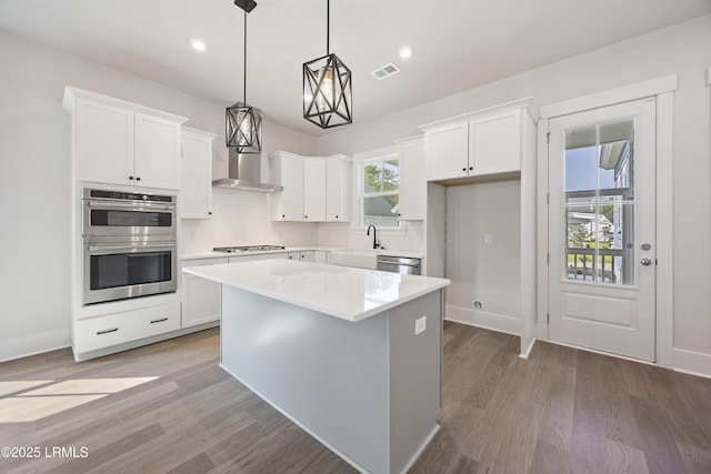 14 Skipperling Ct, Bluffton, SC 29909 - kitchen featuring a sink, appliances with stainless steel finishes, a center island, white cabinets, and decorative backsplash