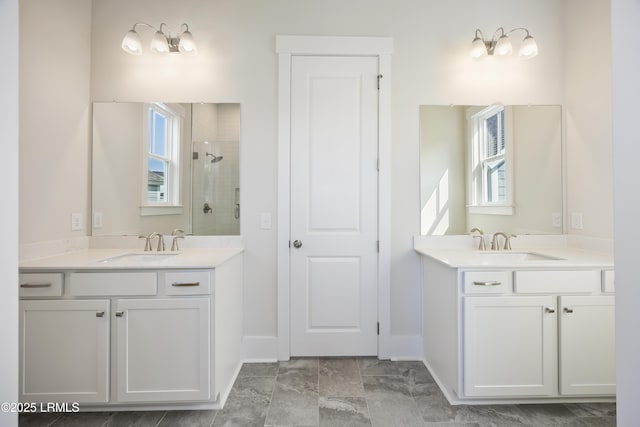 14 Skipperling Ct, Bluffton, SC 29909 - bathroom featuring a stall shower, two vanities, and healthy amount of natural light