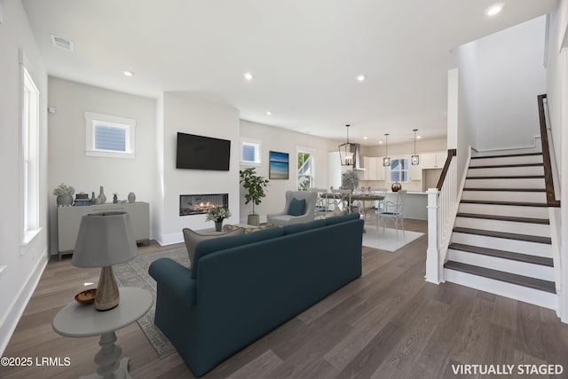 14 Skipperling Ct, Bluffton, SC 29909 - living area with a glass covered fireplace, dark wood-style floors, stairway, recessed lighting, and plenty of natural light