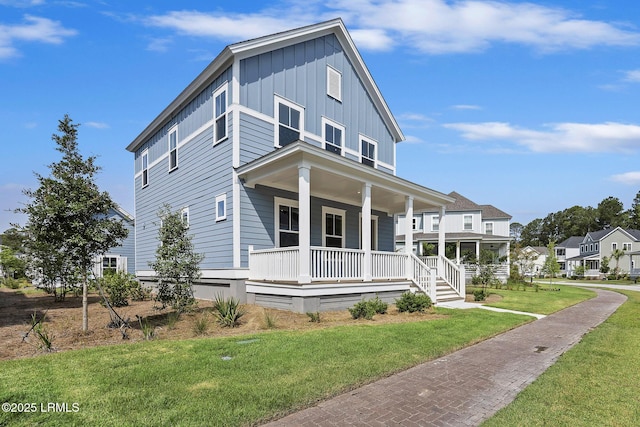 14 Skipperling Ct, Bluffton, SC 29909 - view of front of home with board and batten siding, a porch, and a front lawn