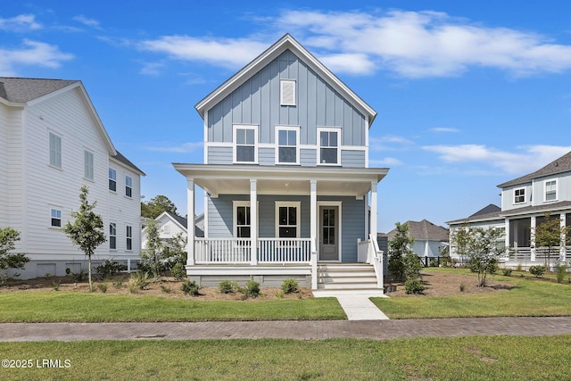 14 Skipperling Ct, Bluffton, SC 29909 - traditional style home with board and batten siding, covered porch, and a front yard