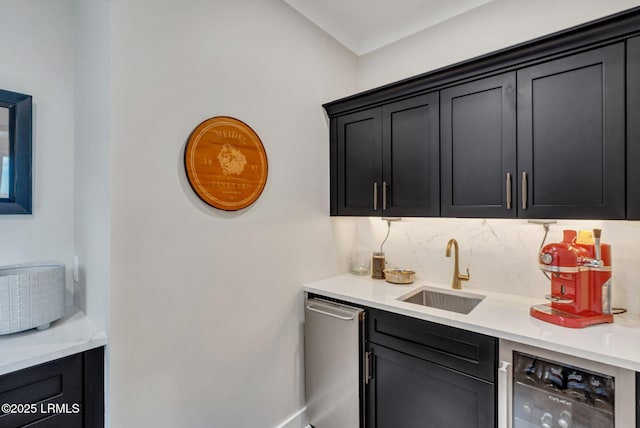 bar featuring tasteful backsplash, stainless steel dishwasher, beverage cooler, and sink