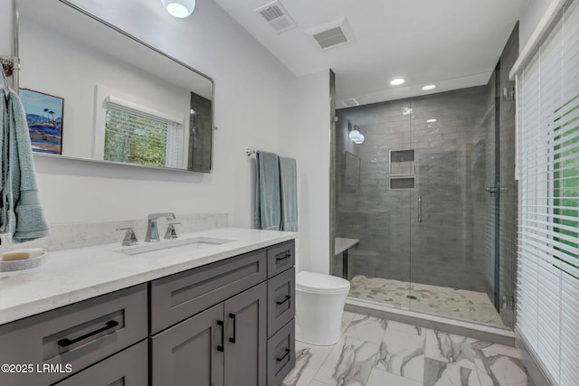 bathroom featuring walk in shower, vanity, and toilet