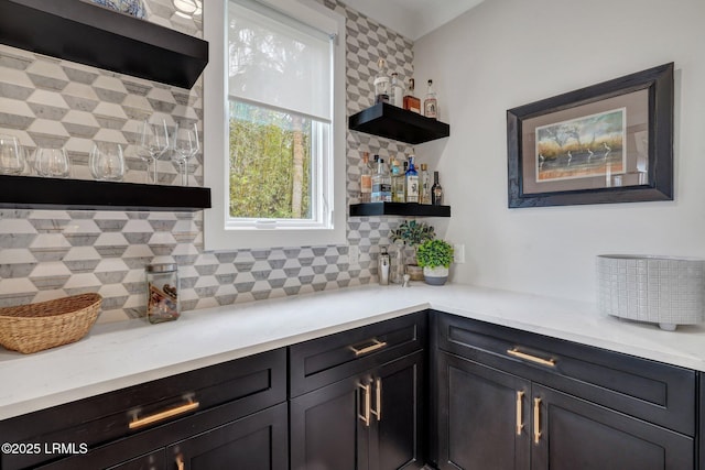 interior space featuring light stone counters and backsplash