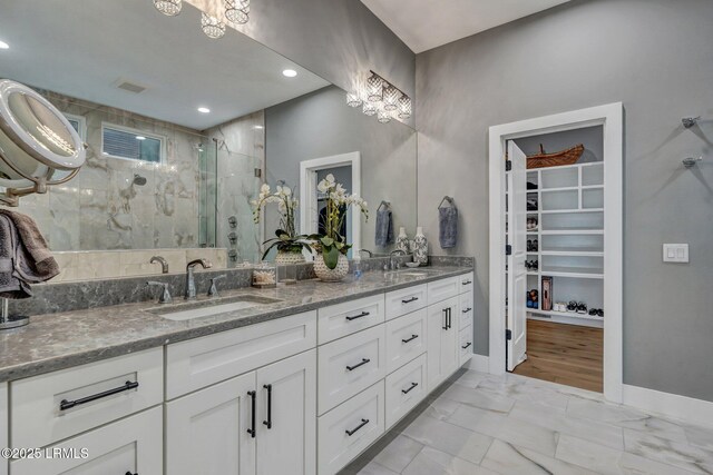 bathroom with vanity and a shower with shower door