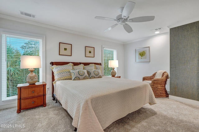 carpeted bedroom with ceiling fan, ornamental molding, and multiple windows