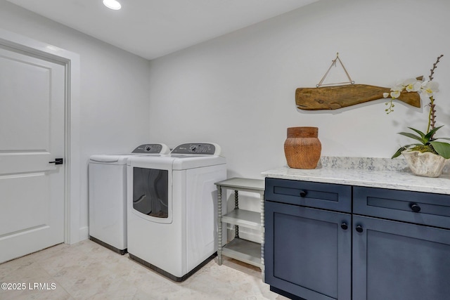 laundry room with cabinets and washer and dryer