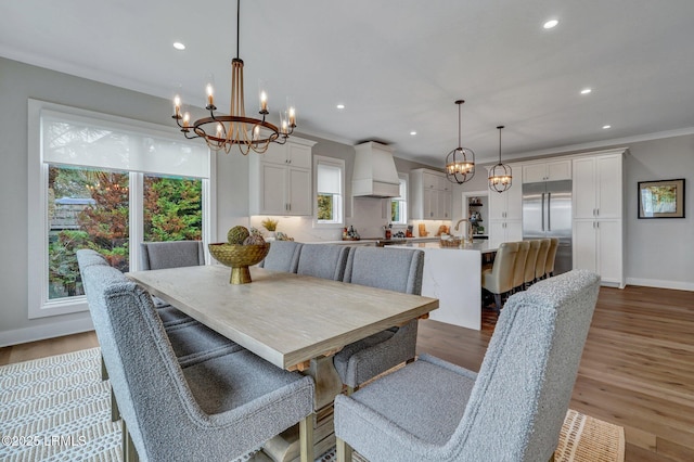 dining area with dark hardwood / wood-style flooring, a notable chandelier, and ornamental molding