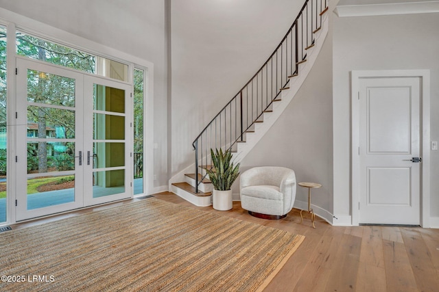 foyer entrance featuring light hardwood / wood-style floors and french doors