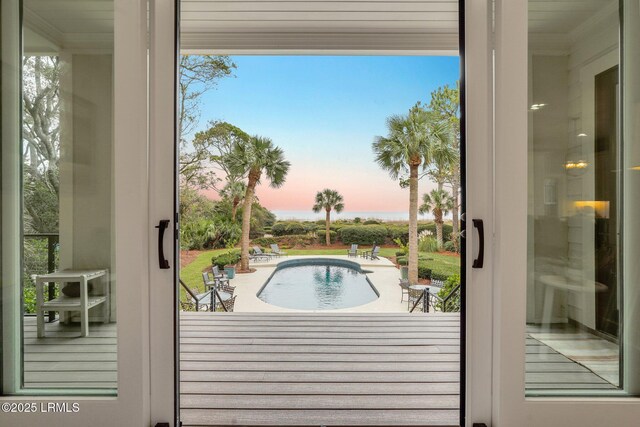 doorway with ornamental molding and plenty of natural light