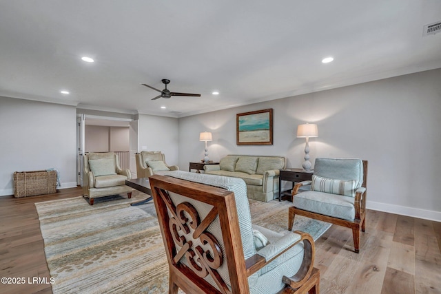 living room with ceiling fan and light hardwood / wood-style floors