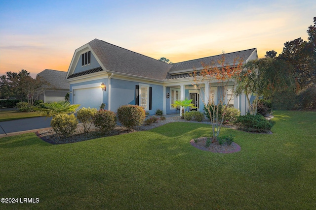 view of front facade with a garage and a lawn