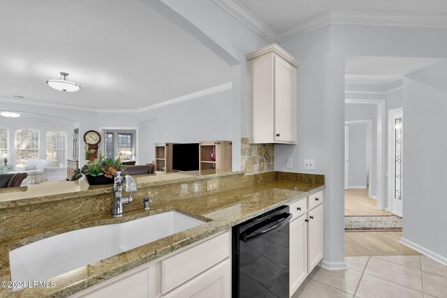 kitchen with white cabinetry, black dishwasher, sink, and light tile patterned floors