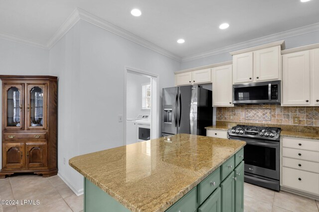 kitchen featuring crown molding, stainless steel appliances, a center island, and green cabinets