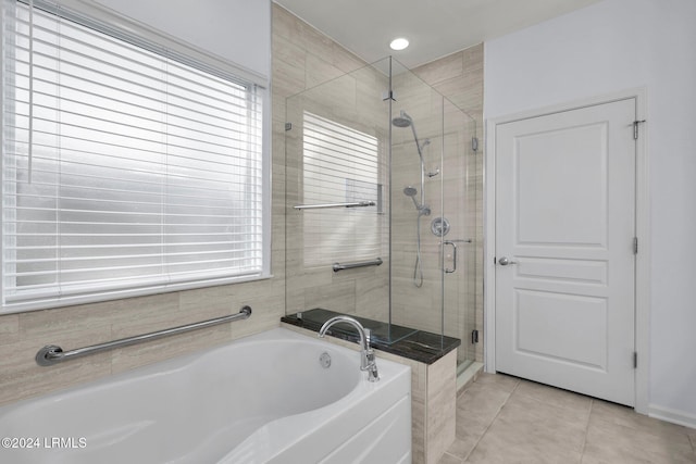 bathroom with tile patterned floors and plus walk in shower