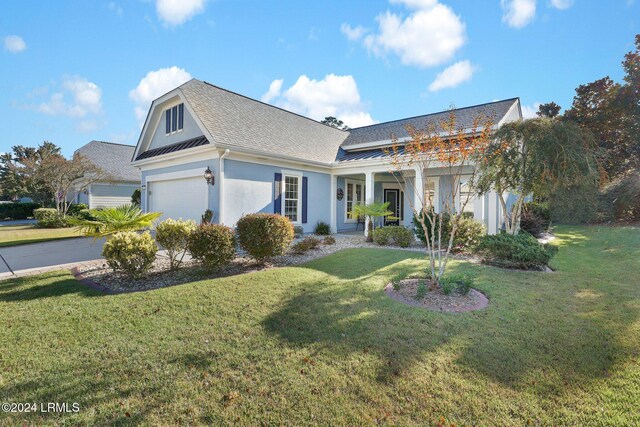 view of front of property with a garage and a front yard