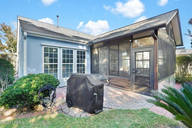 back of property featuring a sunroom