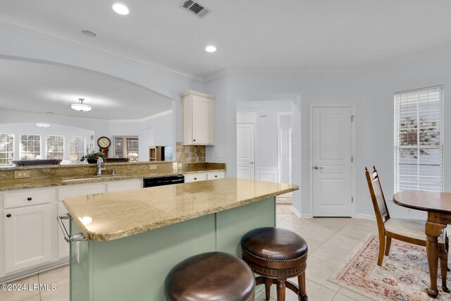 kitchen with light stone counters, kitchen peninsula, and a kitchen island