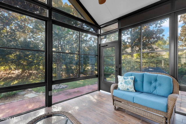 unfurnished sunroom featuring a wealth of natural light, vaulted ceiling, and ceiling fan