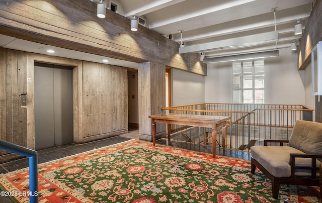 sitting room with elevator and wood walls