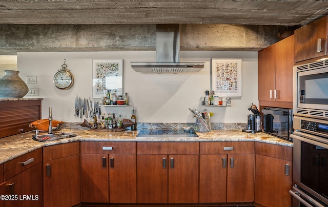 kitchen featuring sink, island range hood, stainless steel appliances, and light stone countertops