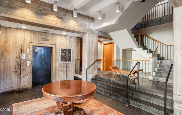 interior space featuring elevator and wooden walls