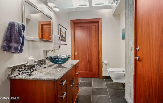 bathroom with vanity, tile patterned floors, and toilet