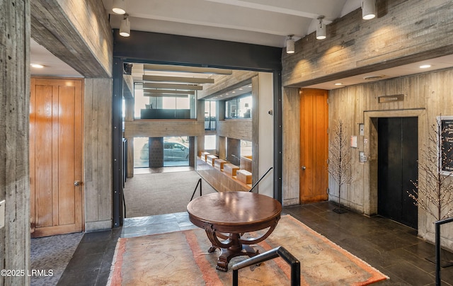 corridor featuring wooden walls and beamed ceiling