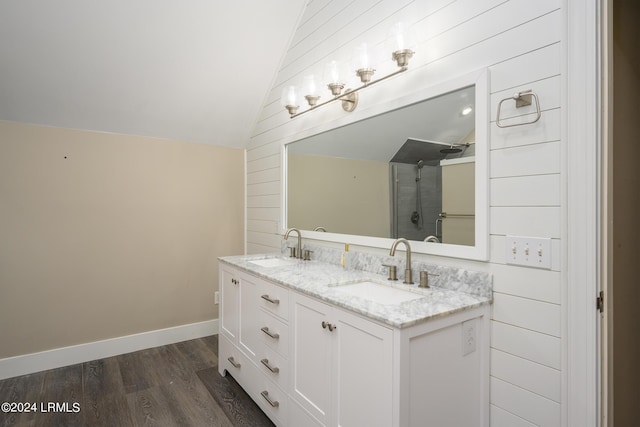 bathroom with lofted ceiling, vanity, and hardwood / wood-style flooring