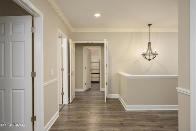 corridor with ornamental molding and dark hardwood / wood-style floors