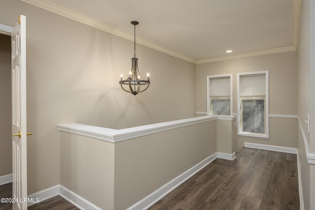 hall featuring ornamental molding, an inviting chandelier, and dark hardwood / wood-style flooring