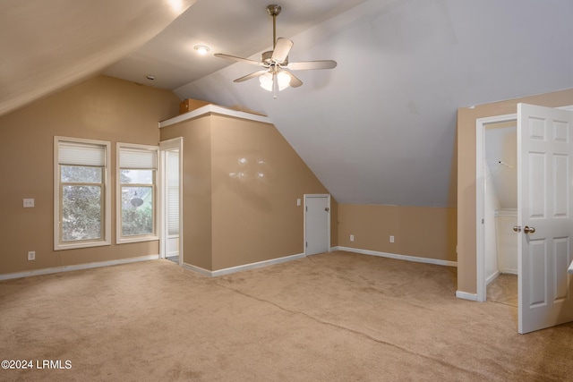 bonus room with lofted ceiling, light colored carpet, and ceiling fan