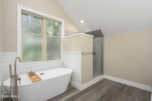 bathroom with lofted ceiling, wood-type flooring, and plus walk in shower