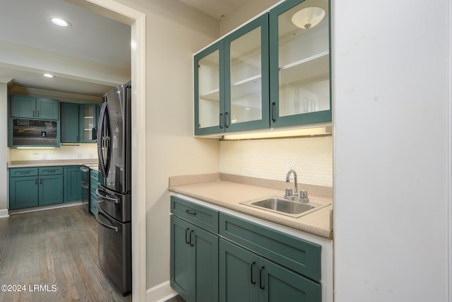 kitchen featuring sink, dark wood-type flooring, stainless steel refrigerator, green cabinets, and decorative backsplash