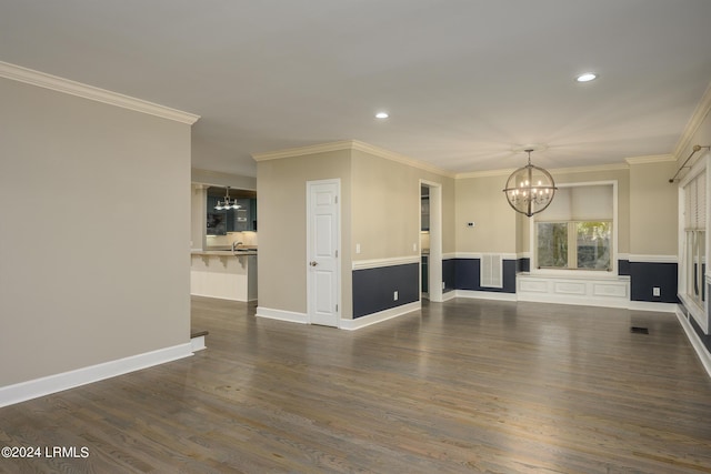 unfurnished living room featuring an inviting chandelier, sink, ornamental molding, and dark hardwood / wood-style floors