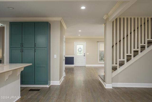 entryway featuring crown molding and dark wood-type flooring