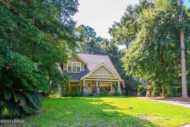 view of front facade with a front yard and a porch