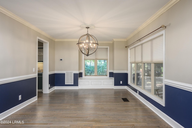 unfurnished dining area with dark wood-type flooring, ornamental molding, and a chandelier