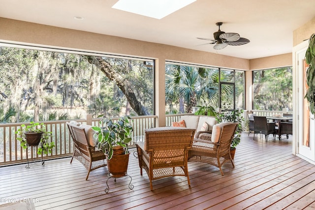 sunroom / solarium with ceiling fan and a skylight