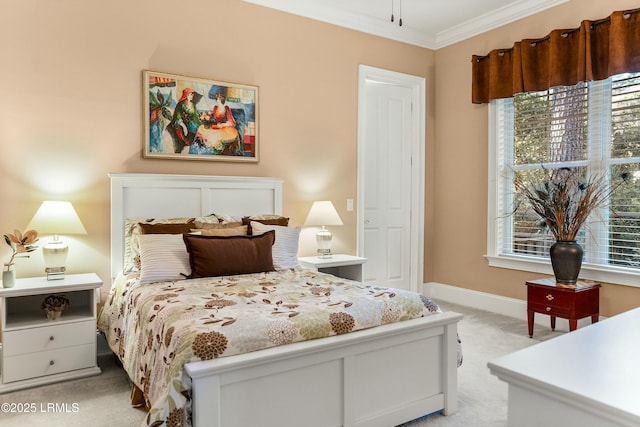 bedroom featuring ornamental molding, light colored carpet, and baseboards